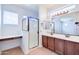 Bright bathroom features double sinks, a walk-in glass shower and a vanity area at 3514 S Posse Trl, Gilbert, AZ 85297