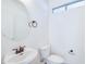 Small bathroom featuring a stylish round mirror, white fixtures, and bronze hardware at 3514 S Posse Trl, Gilbert, AZ 85297