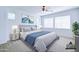 Staged bedroom with a large bed, nightstands, lamps, wall art, and a ceiling fan at 3514 S Posse Trl, Gilbert, AZ 85297