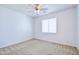 This bedroom has neutral carpeting, ceiling fan, and a window at 3514 S Posse Trl, Gilbert, AZ 85297