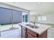 Open kitchen boasts a large island with a sink and sliding glass doors to the outdoor space at 3514 S Posse Trl, Gilbert, AZ 85297