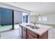 Open kitchen boasts a large island with a sink and sliding glass doors to the outdoor space at 3514 S Posse Trl, Gilbert, AZ 85297