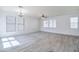 Spacious living room showcasing neutral tones, plank floors, and abundant natural light at 3514 S Posse Trl, Gilbert, AZ 85297