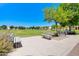 Inviting community park with benches surrounded by mature trees and lush green space, perfect for relaxation at 3514 S Posse Trl, Gilbert, AZ 85297