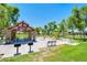 Community park featuring covered picnic pavilion with BBQ grills, playground, green spaces, and mature trees providing shade at 3514 S Posse Trl, Gilbert, AZ 85297