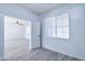 Bright room with neutral walls, floors, large window and an open doorway leading to another room at 3514 S Posse Trl, Gilbert, AZ 85297
