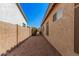 Gravel-covered side yard with block wall and access gate at 371 W Indigo Dr, Chandler, AZ 85248