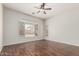 Bright bedroom features a ceiling fan, natural light, and wood floors at 371 W Indigo Dr, Chandler, AZ 85248