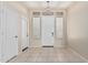 Bright foyer with tile flooring, white doors and a decorative chandelier at 371 W Indigo Dr, Chandler, AZ 85248