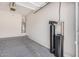 View of the home's unfinished garage with concrete floors, water heater and water filtration system at 371 W Indigo Dr, Chandler, AZ 85248
