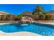Sparkling pool with a rock waterfall feature, complemented by lush landscaping, offering a private backyard oasis at 371 W Indigo Dr, Chandler, AZ 85248