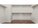 Organized walk-in closet features wood floors and multiple shelves for maximum storage at 371 W Indigo Dr, Chandler, AZ 85248