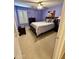 This carpeted bedroom features lavender walls, a ceiling fan, and a window with plantation shutters at 3891 E Simpson Rd, Gilbert, AZ 85297