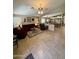 Open-concept living room with tile flooring and neutral colors, seamlessly connecting to the kitchen and dining area at 3891 E Simpson Rd, Gilbert, AZ 85297