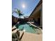 Inviting backyard pool with desert landscaping, clear blue water, string lights and a spacious patio for relaxing and entertaining at 3891 E Simpson Rd, Gilbert, AZ 85297