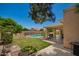 Spacious backyard with a covered patio, barbecue grill, and fenced pool, perfect for outdoor gatherings and relaxation at 400 W Crofton St, Chandler, AZ 85225