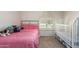 Charming bedroom features a bed, shuttered window, crib and neutral carpet at 400 W Crofton St, Chandler, AZ 85225