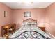 Inviting bedroom featuring a patterned bedspread, shutters, desk, and wooden furniture at 400 W Crofton St, Chandler, AZ 85225