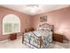 Comfortable bedroom with a patterned bedspread, shutters, desk, and wooden furniture at 400 W Crofton St, Chandler, AZ 85225