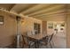 Relaxing covered patio with a dining table, heater, and outdoor bar area for entertaining and enjoying the outdoors at 400 W Crofton St, Chandler, AZ 85225