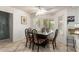 Bright breakfast nook with bay windows, a ceiling fan, and a table with ornate metal chairs at 400 W Crofton St, Chandler, AZ 85225