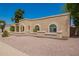Attractive single-story home with well-maintained landscape, arched windows and colorful plants adding visual interest at 400 W Crofton St, Chandler, AZ 85225