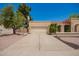 Spacious two-car garage with a well-maintained driveway and lush plants framing the entrance, offering convenience at 400 W Crofton St, Chandler, AZ 85225
