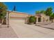 Spacious two-car garage with a well-maintained driveway and lush plants framing the entrance, offering convenience at 400 W Crofton St, Chandler, AZ 85225