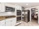 Stainless steel appliances, double oven and granite countertops complete this updated kitchen at 400 W Crofton St, Chandler, AZ 85225