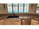 Kitchen featuring granite countertops with a stainless steel sink and view of the backyard pool at 400 W Crofton St, Chandler, AZ 85225