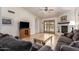 Open-concept living room with hardwood floors, a fireplace, and access to the backyard pool at 400 W Crofton St, Chandler, AZ 85225