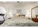 Spacious bedroom with floral bedding, bedside lamps, and an adjacent workout area at 400 W Crofton St, Chandler, AZ 85225