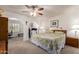 Comfortable main bedroom featuring carpet floors, ceiling fan, and adjacent exercise/office space at 400 W Crofton St, Chandler, AZ 85225