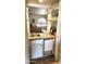 Elegant wet bar with granite countertop, glass shelving, and cabinetry perfect for entertaining in style at 400 W Crofton St, Chandler, AZ 85225