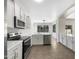 All white kitchen featuring stainless steel appliances, and large windows that provide natural lighting at 4229 E Betsy Ln, Gilbert, AZ 85296