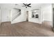 Open-concept living space featuring wood floors, ceiling fan, and an adjacent kitchen area at 4229 E Betsy Ln, Gilbert, AZ 85296