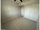 Bedroom features tile flooring, a ceiling fan, and a double door closet for storage at 4425 W Sierra St, Glendale, AZ 85304