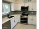 Updated kitchen features stainless steel appliances, gray backsplash, and modern fixtures at 4425 W Sierra St, Glendale, AZ 85304