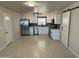 Modern kitchen featuring stainless steel appliances, white cabinetry, and a barn door pantry at 4425 W Sierra St, Glendale, AZ 85304