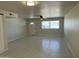 Open living room area featuring tile flooring, a ceiling fan, and a bright front window at 4425 W Sierra St, Glendale, AZ 85304