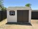 Outdoor storage shed with gray shingles and brown doors at 4425 W Sierra St, Glendale, AZ 85304