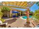Inviting backyard featuring a pool, pergola, and lush landscaping, creating a perfect outdoor oasis for relaxation at 4511 E Kirkland Rd, Phoenix, AZ 85050