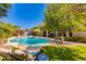 Lush backyard featuring a sparkling pool, comfortable lounge chairs, and vibrant greenery, perfect for relaxing and entertaining at 4511 E Kirkland Rd, Phoenix, AZ 85050