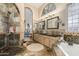 Luxurious bathroom showcasing dual sinks, tiled accents, a shower, and soaking tub at 4511 E Kirkland Rd, Phoenix, AZ 85050
