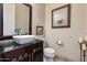 Powder room with granite countertop, vessel sink, framed mirror and artwork, and tile flooring at 4511 E Kirkland Rd, Phoenix, AZ 85050