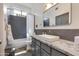 Gray bathroom with modern vanity, vessel sink, and tiled shower-tub combo at 4511 E Kirkland Rd, Phoenix, AZ 85050