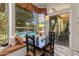 Bright dining area with large window overlooking pool, black table, and built in bench seating at 4511 E Kirkland Rd, Phoenix, AZ 85050