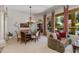 Elegant dining and living area with neutral tones, decorative columns, and a view of the backyard pool at 4511 E Kirkland Rd, Phoenix, AZ 85050