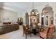 Spacious dining area with classic furnishings, decorative columns, and seamless flow to other living spaces at 4511 E Kirkland Rd, Phoenix, AZ 85050