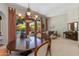 Dining area with a chandelier, round wood table and large windows overlooking the pool and backyard at 4511 E Kirkland Rd, Phoenix, AZ 85050
